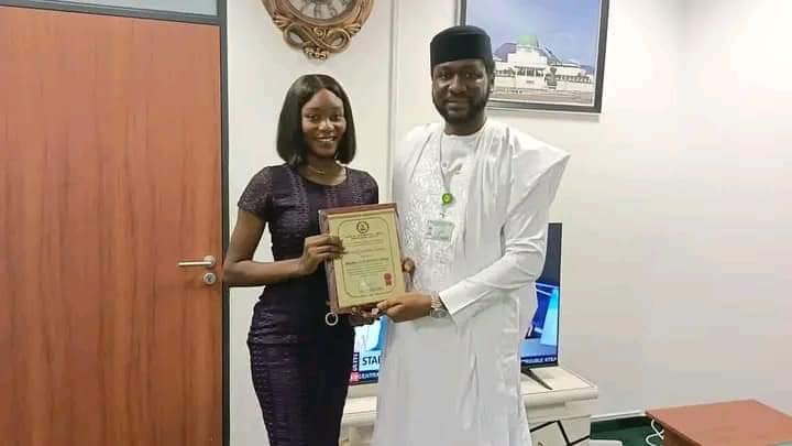 HON.UGBOR WITH A FEMALE BENEFICIARY OF SCHOLARSHIP NGI